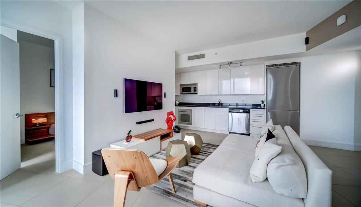 92 Southwest 3rd Street, Unit 1606 Miami, FL 33130 - Photo 9 of 62 a living room with furniture and flat screen tv
