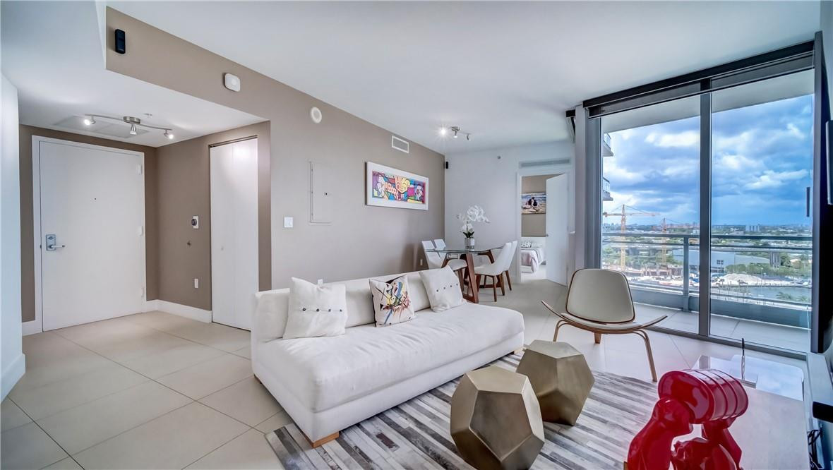 92 Southwest 3rd Street, Unit 1606 Miami, FL 33130 - Photo 10 of 62 a living room with furniture and a floor to ceiling window