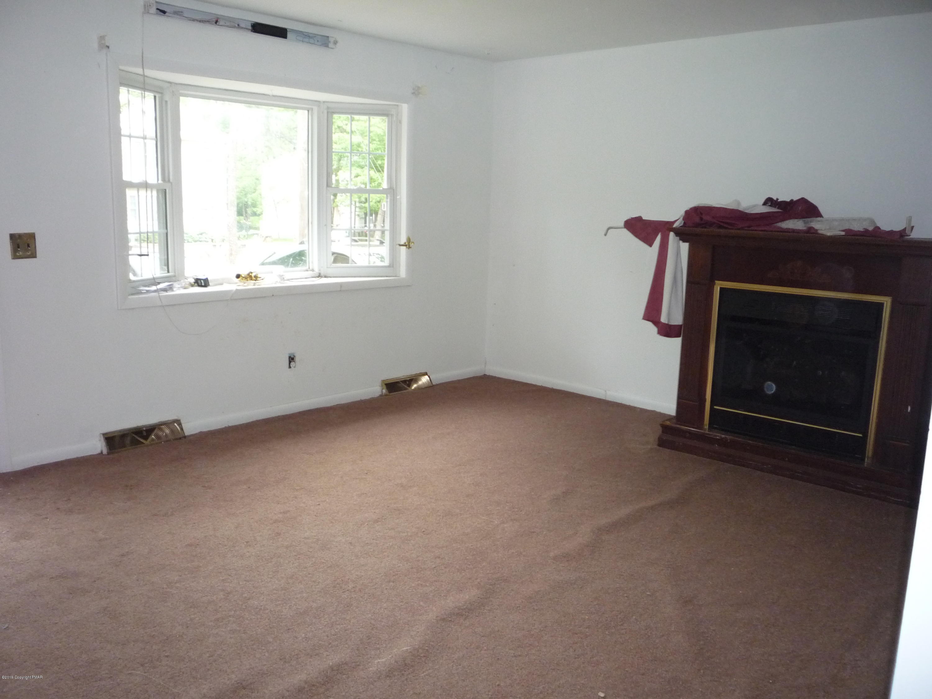 6281 Laurel Road Pocono Summit, PA 18346 - Photo 2 of 10 a view of an empty room with a fireplace