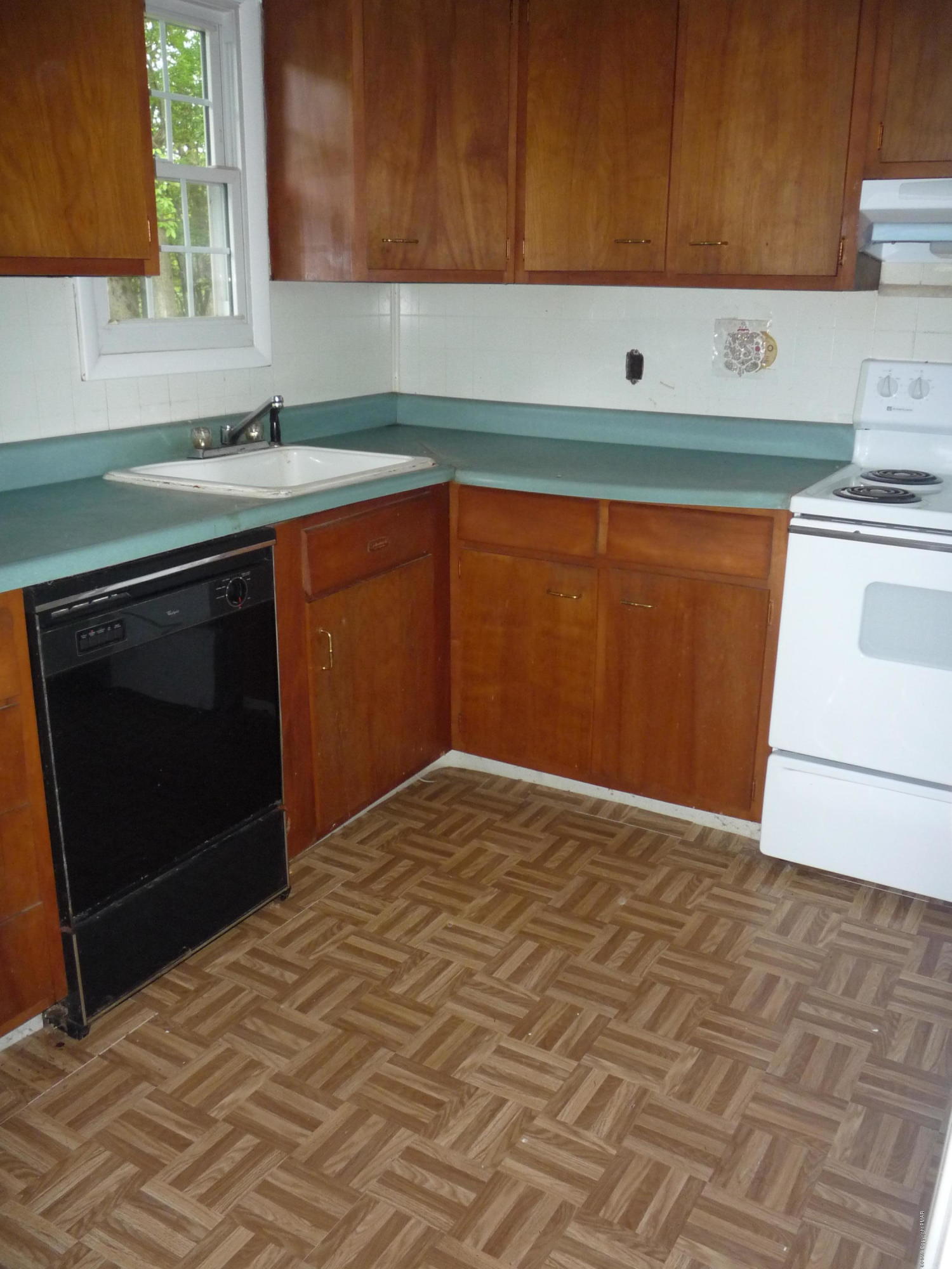 6281 Laurel Road Pocono Summit, PA 18346 - Photo 4 of 10 a kitchen with a cabinets and a stove top oven