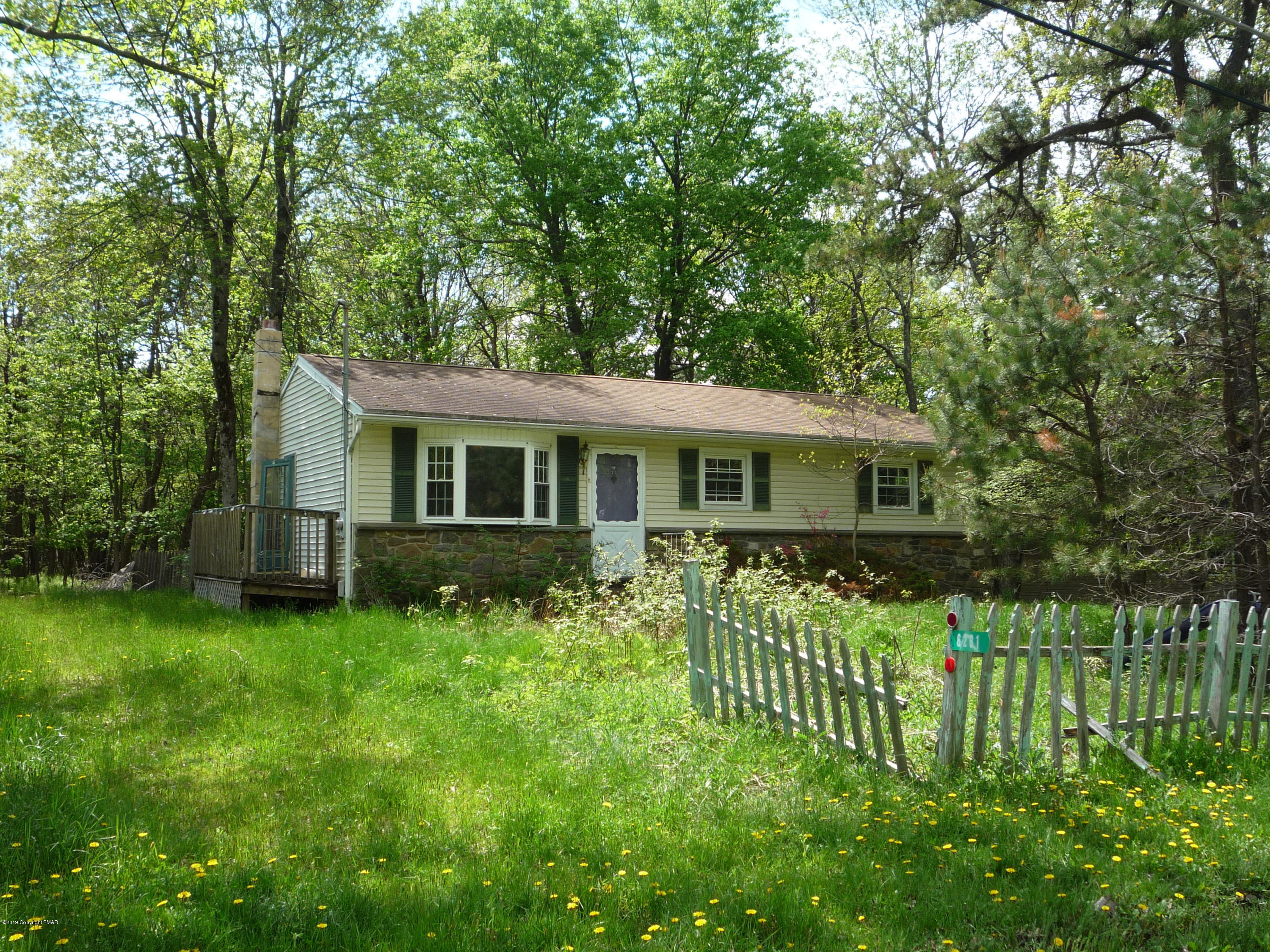 6281 Laurel Road Pocono Summit, PA 18346 - Photo 10 of 10 a front view of a house with a garden