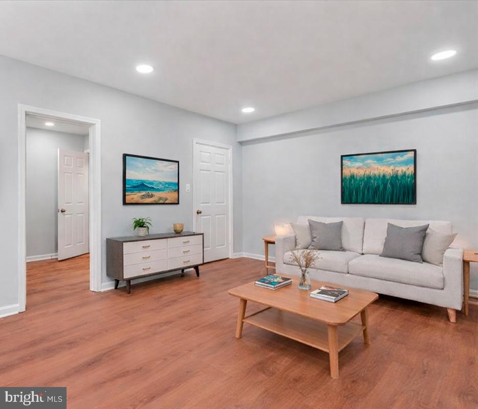 1909 North Rhodes Street, Unit 25 Arlington, VA 22201 - Photo 1 of 30 a living room with furniture and a wooden floor