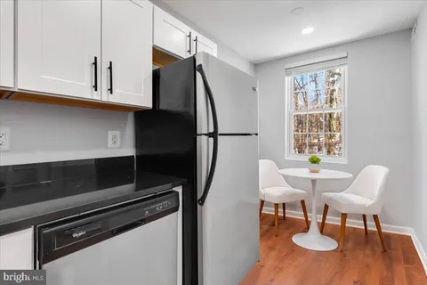 a kitchen with a dining table and chairs
