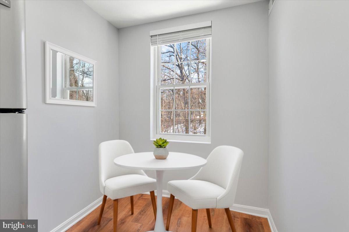1909 North Rhodes Street, Unit 25 Arlington, VA 22201 - Photo 13 of 30 a view of a dining room with furniture and a window