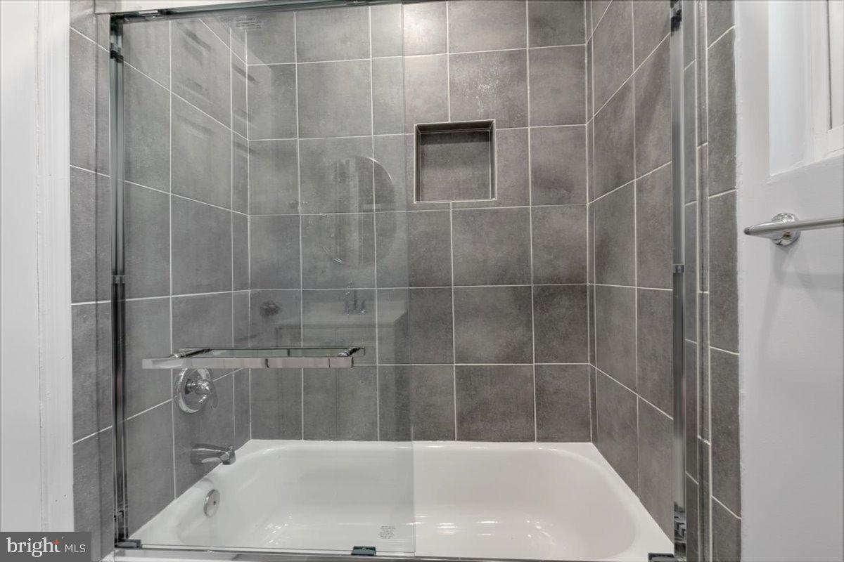 1909 North Rhodes Street, Unit 25 Arlington, VA 22201 - Photo 15 of 30 a bathroom with a white bathtub