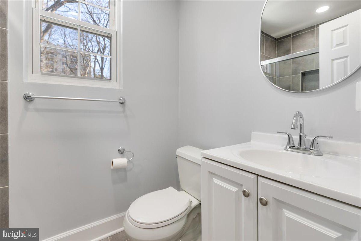 1909 North Rhodes Street, Unit 25 Arlington, VA 22201 - Photo 16 of 30 a bathroom with a toilet a sink and mirror