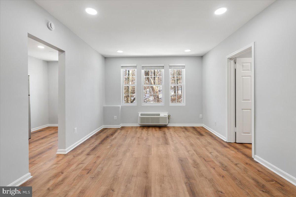 1909 North Rhodes Street, Unit 25 Arlington, VA 22201 - Photo 17 of 30 an empty room with wooden floor and windows