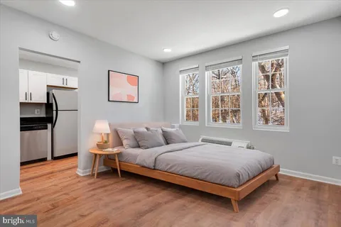 a bedroom with a bed and a window