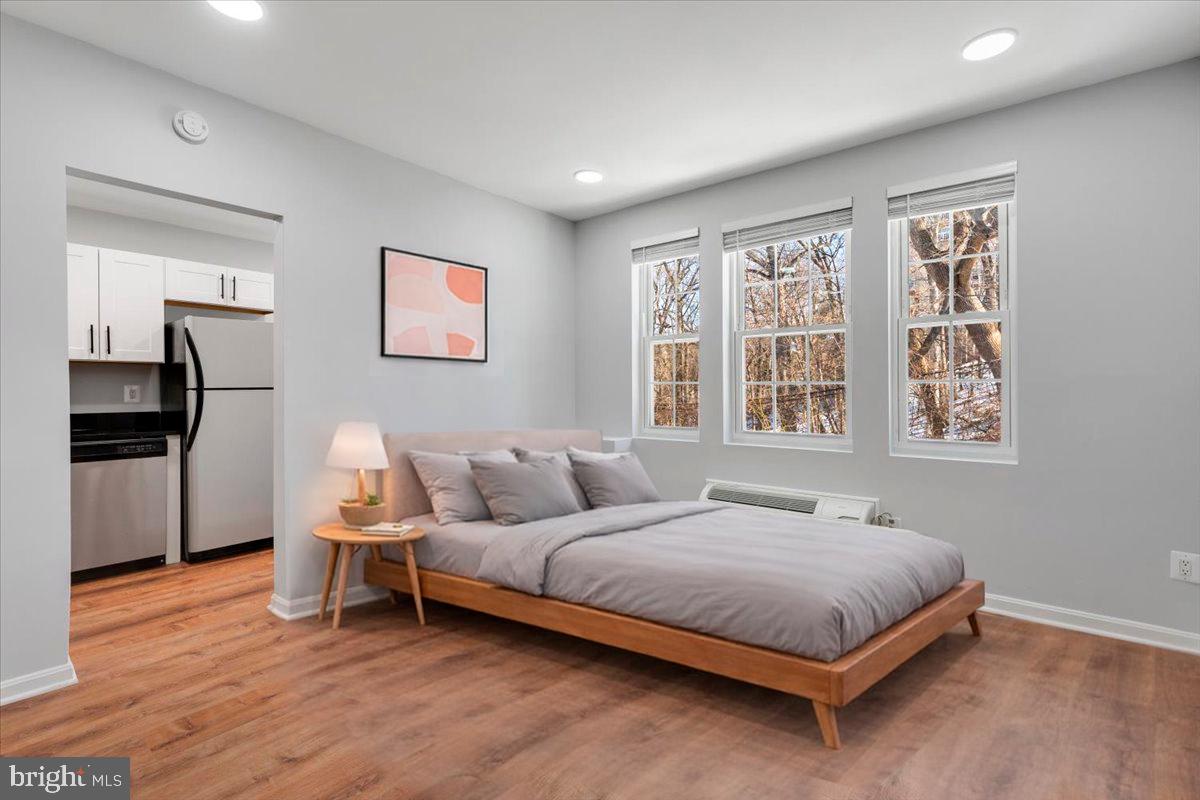 1909 North Rhodes Street, Unit 25 Arlington, VA 22201 - Photo 7 of 30 a bedroom with a bed and a window