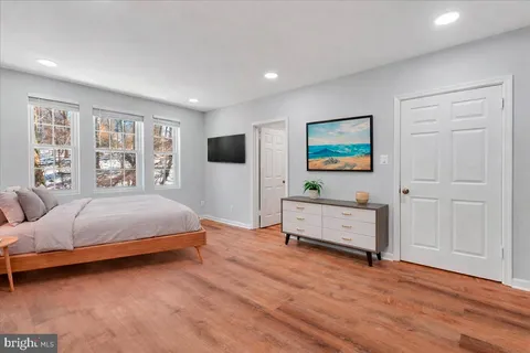 a spacious bedroom with a bed and a window