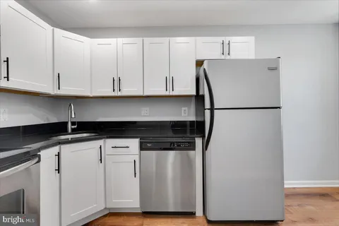 a white refrigerator freezer sitting inside of a kitchen