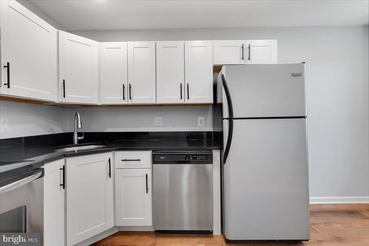 1909 North Rhodes Street, Unit 25 Arlington, VA 22201 - Photo 9 of 30 a white refrigerator freezer sitting inside of a kitchen