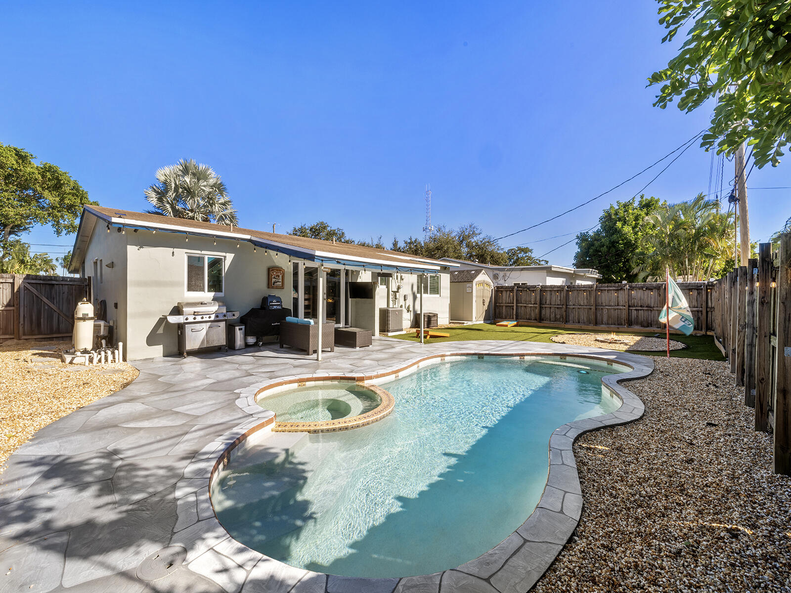 a swimming pool with outdoor seating and yard