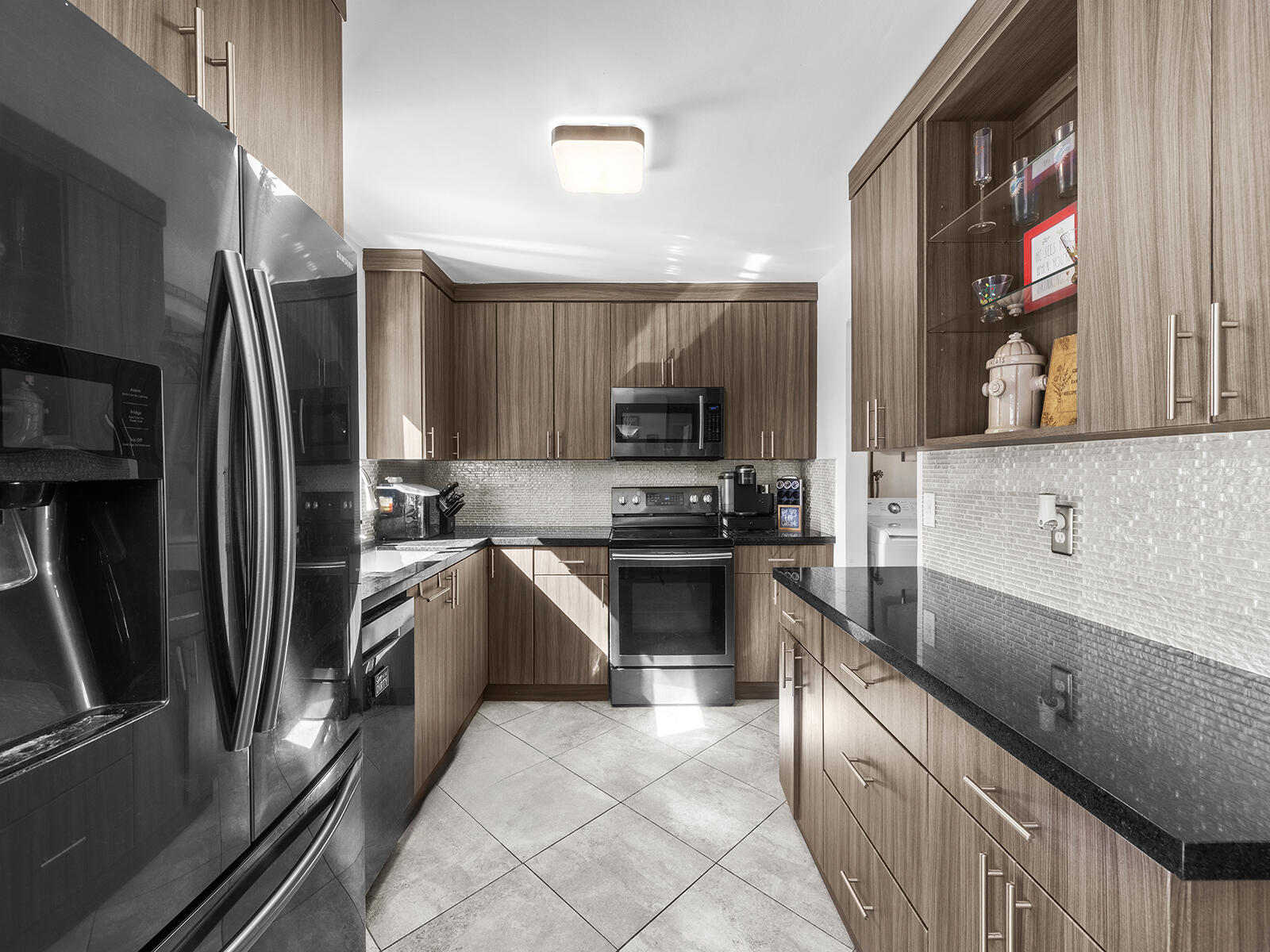 6960 Thomas Street Hollywood, FL 33021 - Photo 11 of 32 a kitchen with stainless steel appliances wooden cabinets a sink and a refrigerator