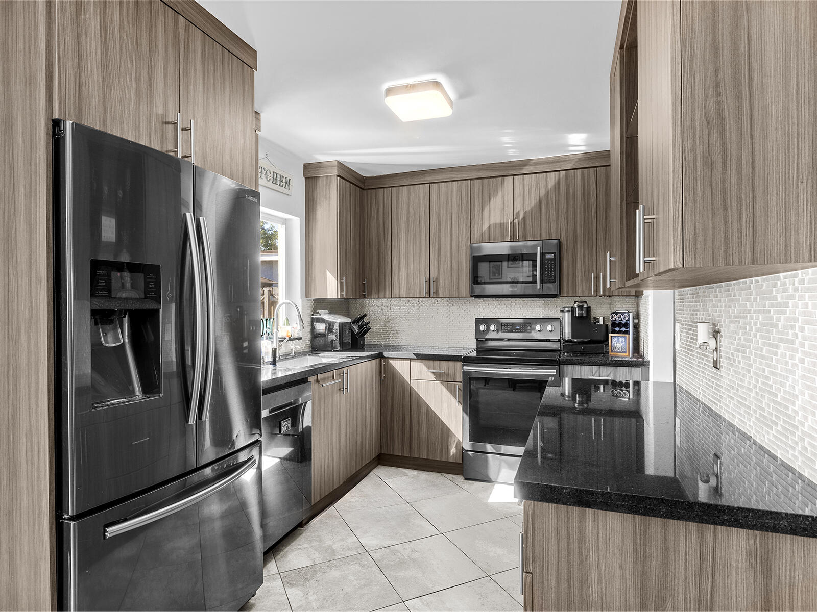 6960 Thomas Street Hollywood, FL 33021 - Photo 12 of 32 a kitchen with a refrigerator stove and microwave