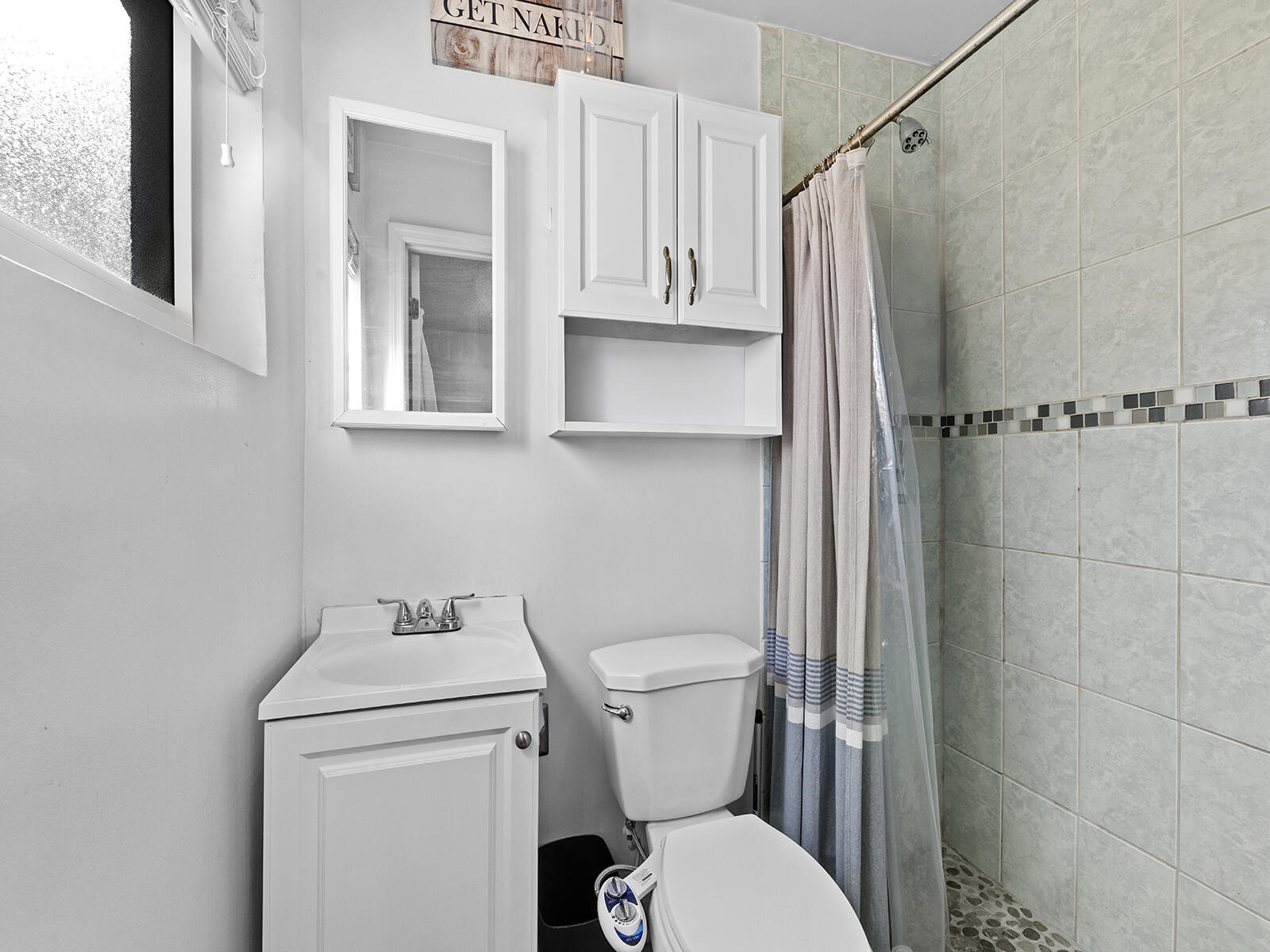 6960 Thomas Street Hollywood, FL 33021 - Photo 17 of 32 a bathroom with a sink a toilet and shower