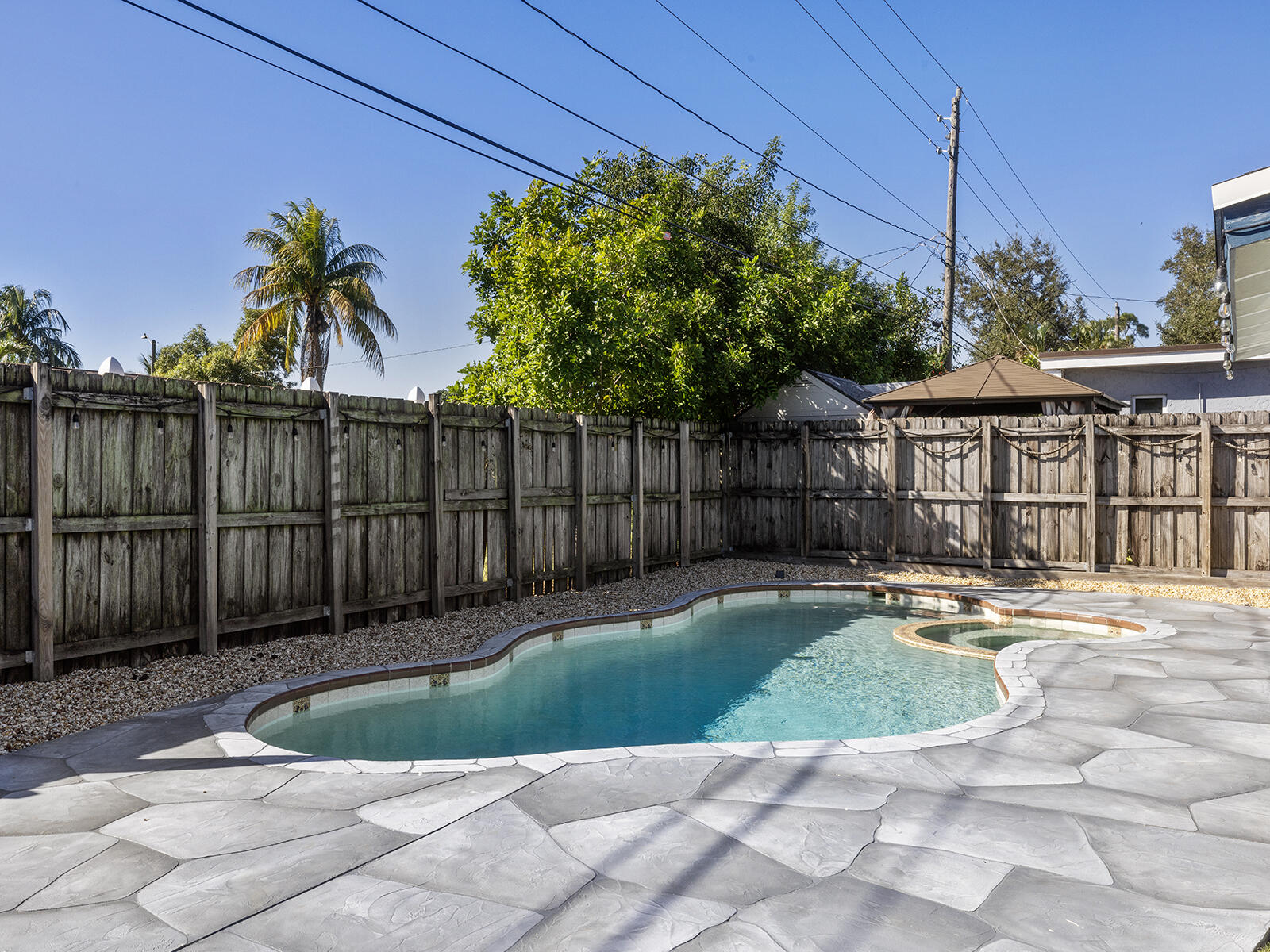 6960 Thomas Street Hollywood, FL 33021 - Photo 24 of 32 a view of a house with a small yard and wooden fence