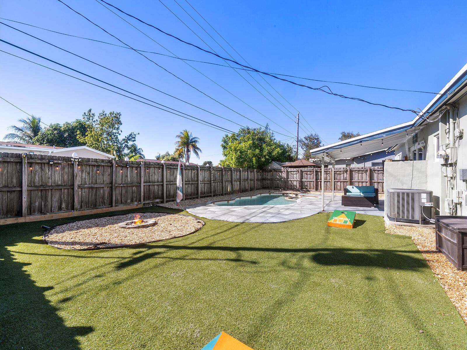 6960 Thomas Street Hollywood, FL 33021 - Photo 29 of 32 a view of a swimming pool with a lounge chairs