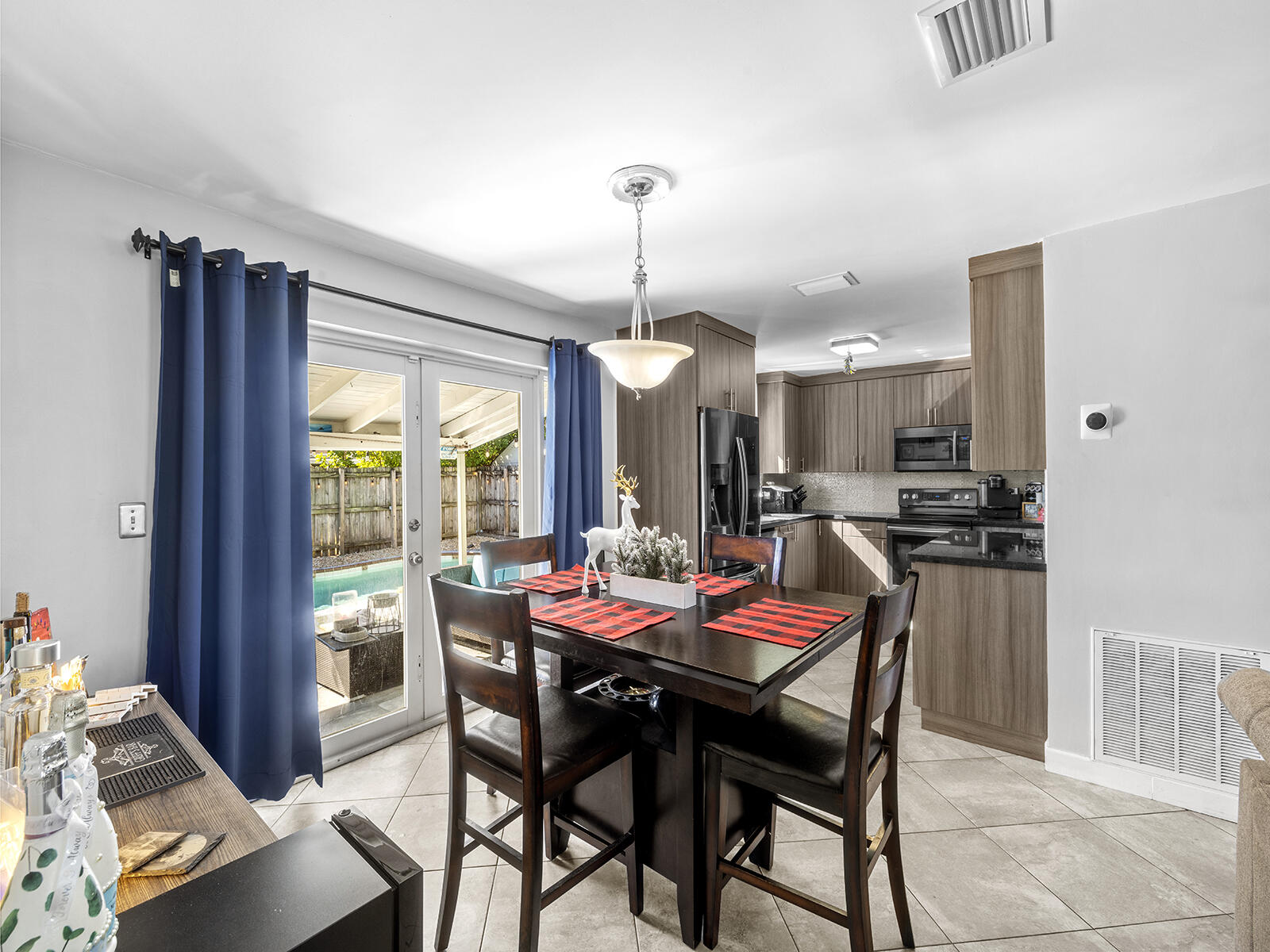6960 Thomas Street Hollywood, FL 33021 - Photo 10 of 32 a dining room with furniture a chandelier and wooden floor