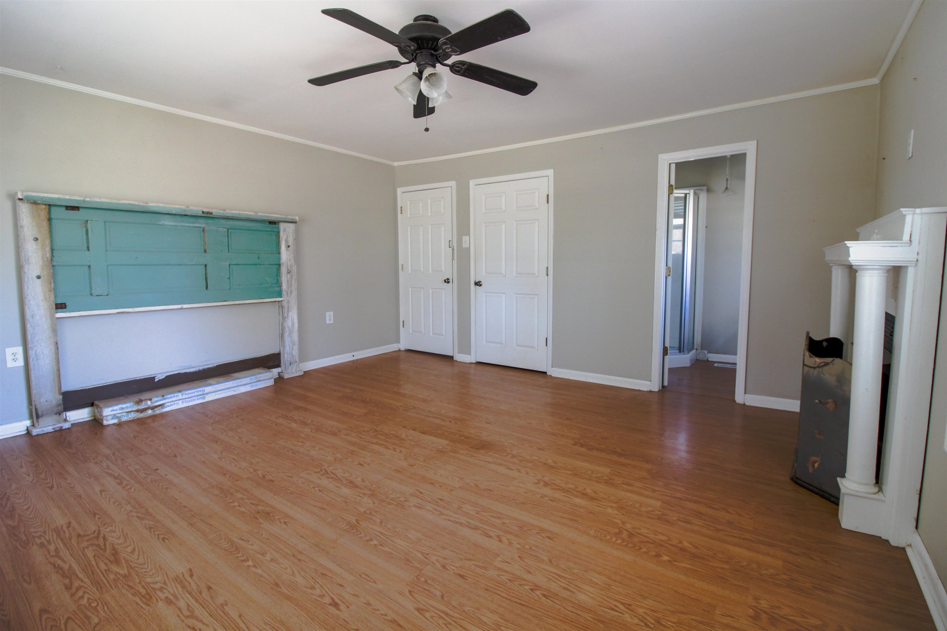143 Marys Chapel Road Ripley, TN 38063 - Photo 11 of 23 Primary Bedroom with build in headboard,built in cabinets,window seat and fireplace.