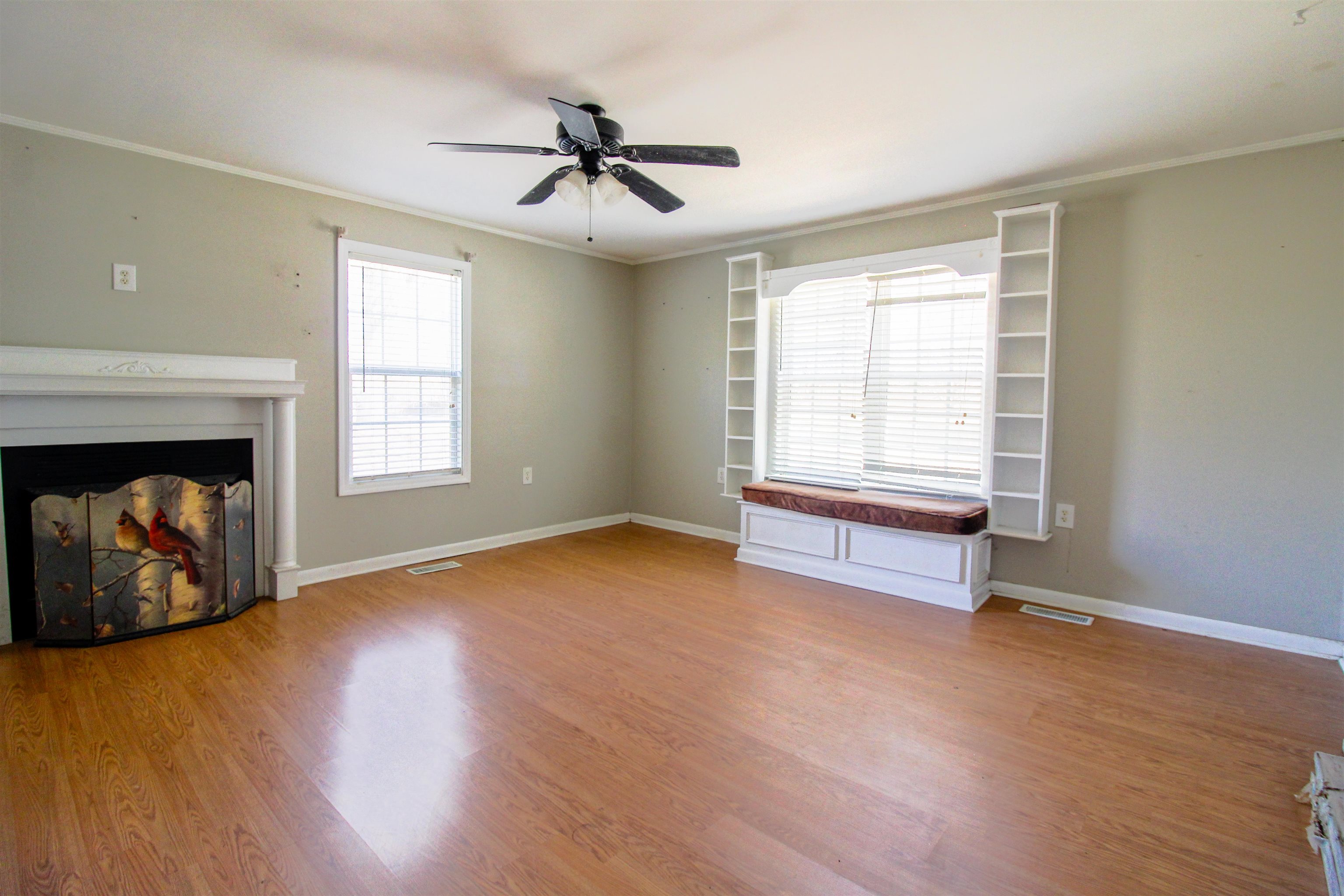 143 Marys Chapel Road Ripley, TN 38063 - Photo 12 of 23 Primary Bedroom with build in headboard,built in cabinets,window seat and fireplace.