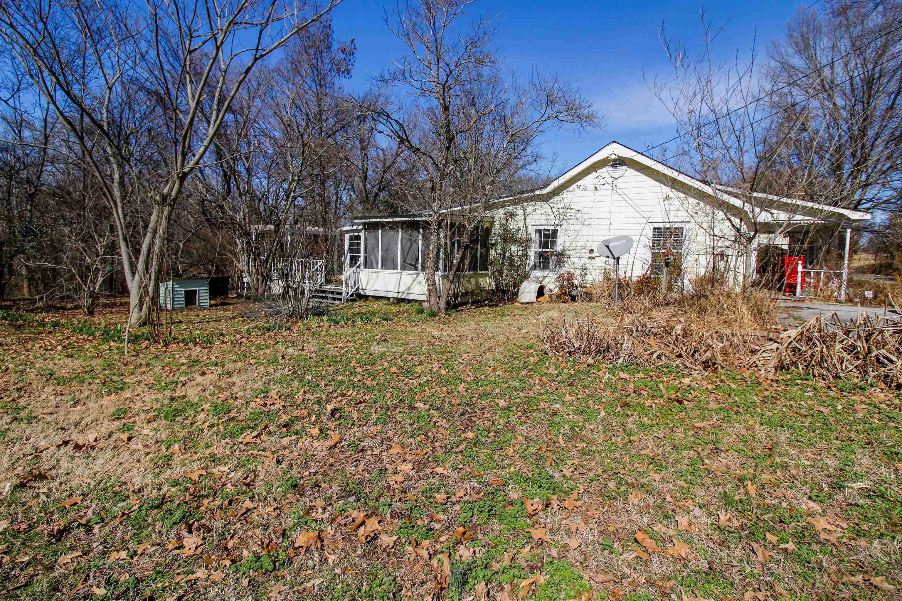 143 Marys Chapel Road Ripley, TN 38063 - Photo 22 of 23 Rear view of property featuring a sunroom and a lawn