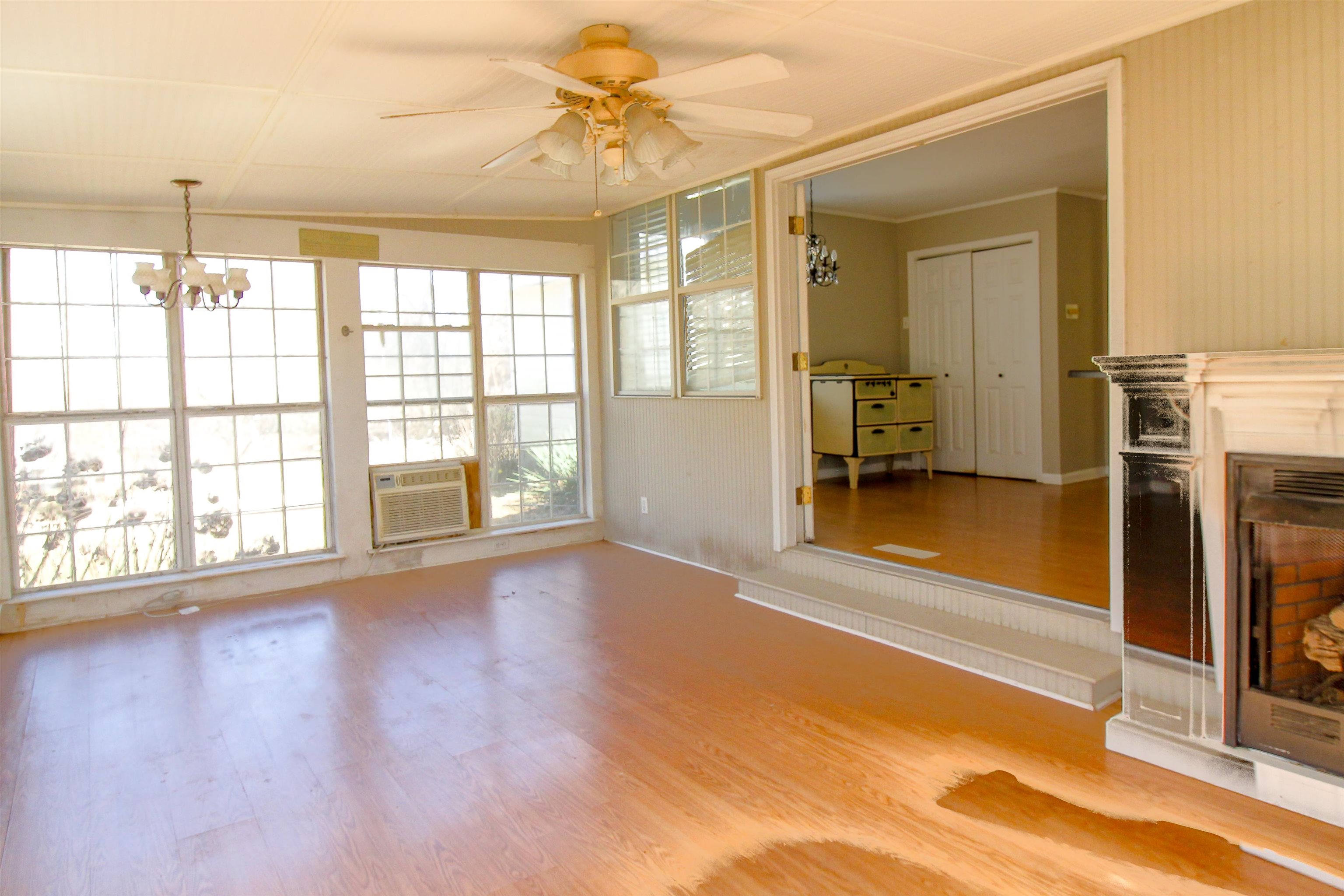143 Marys Chapel Road Ripley, TN 38063 - Photo 7 of 23 Sunroom featuring a ceiling fan and fireplace.