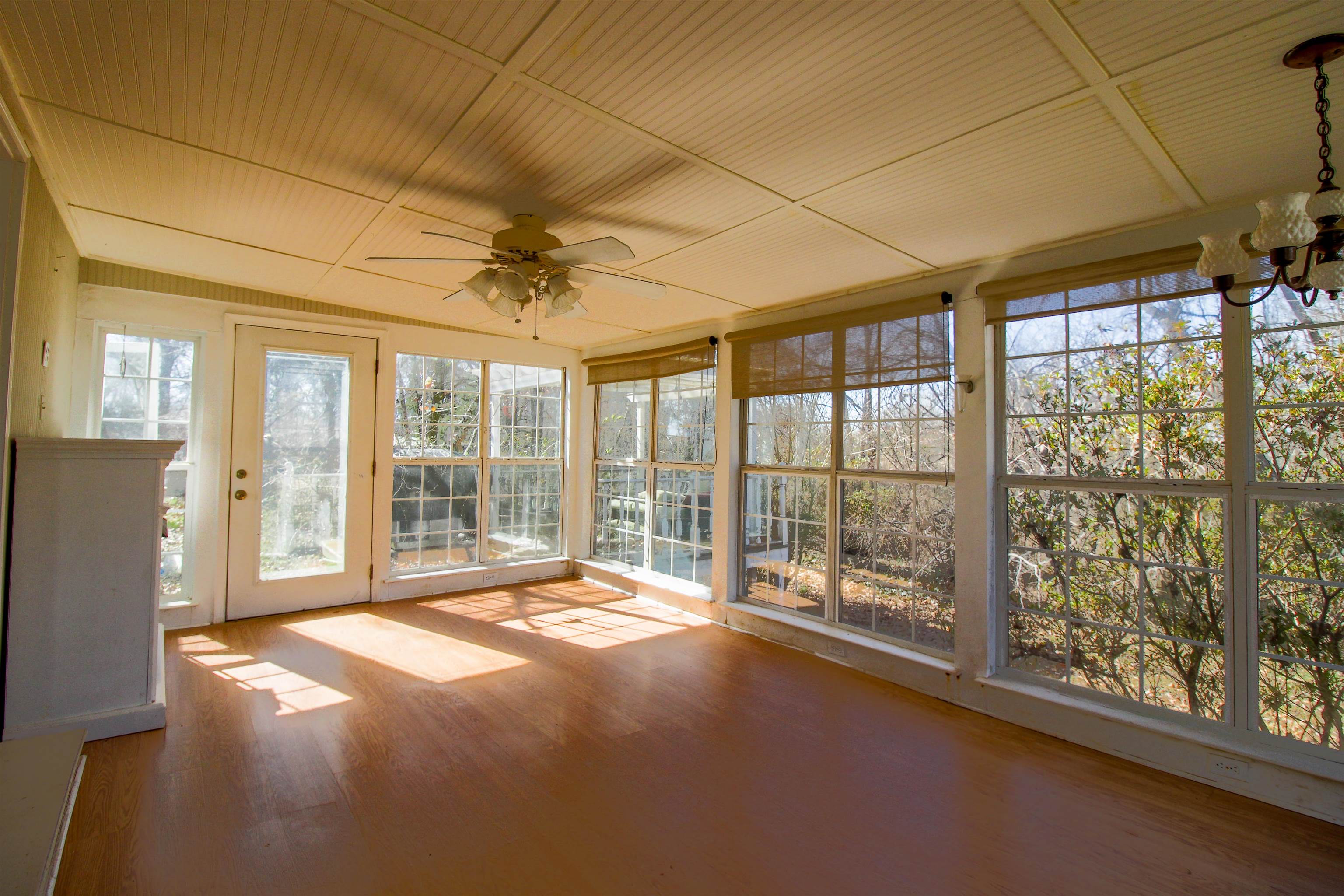 143 Marys Chapel Road Ripley, TN 38063 - Photo 8 of 23 Sunroom featuring a ceiling fan and fireplace.
