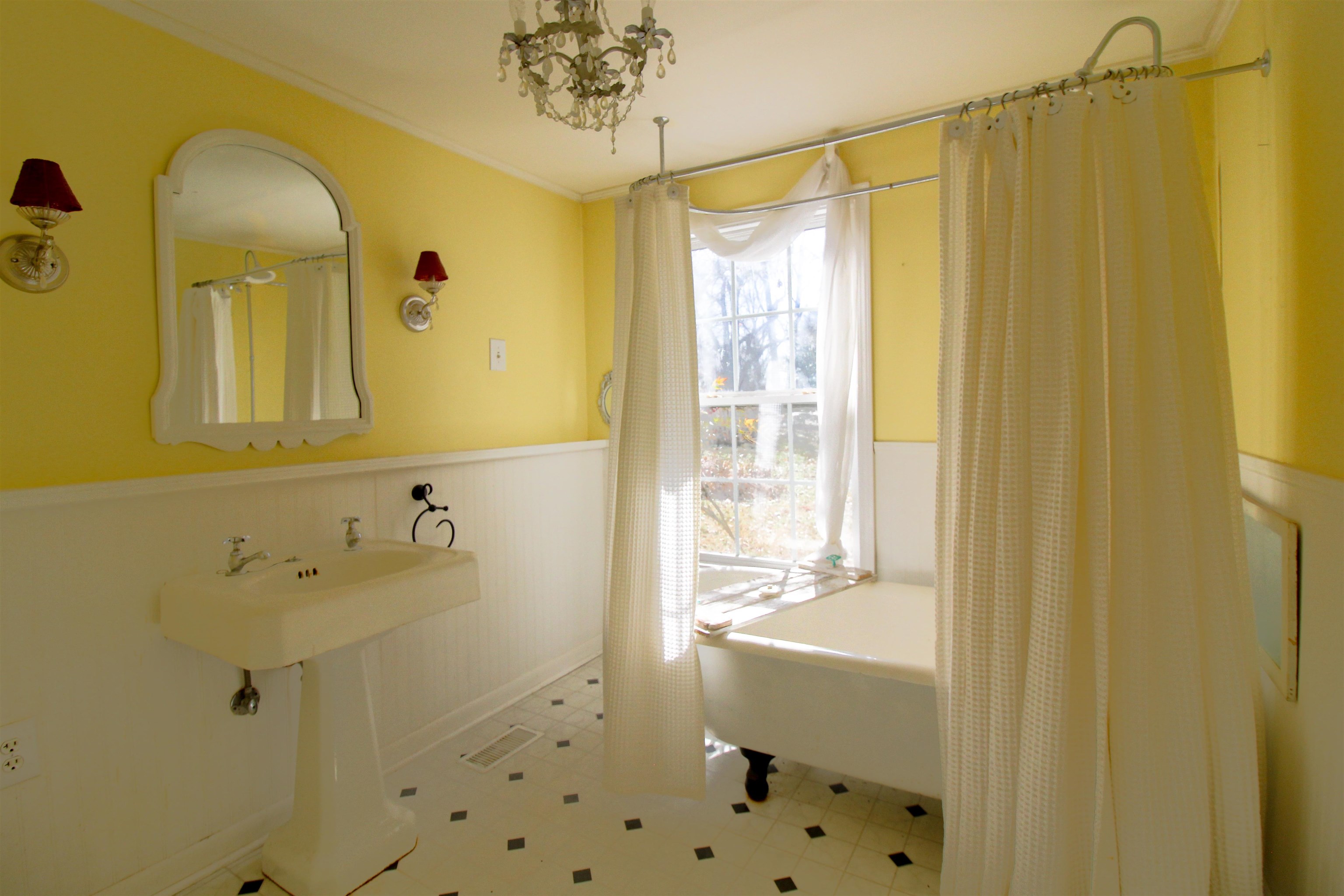 143 Marys Chapel Road Ripley, TN 38063 - Photo 9 of 23 Full bathroom featuring wainscoting ,crown molding and claw foot tub.