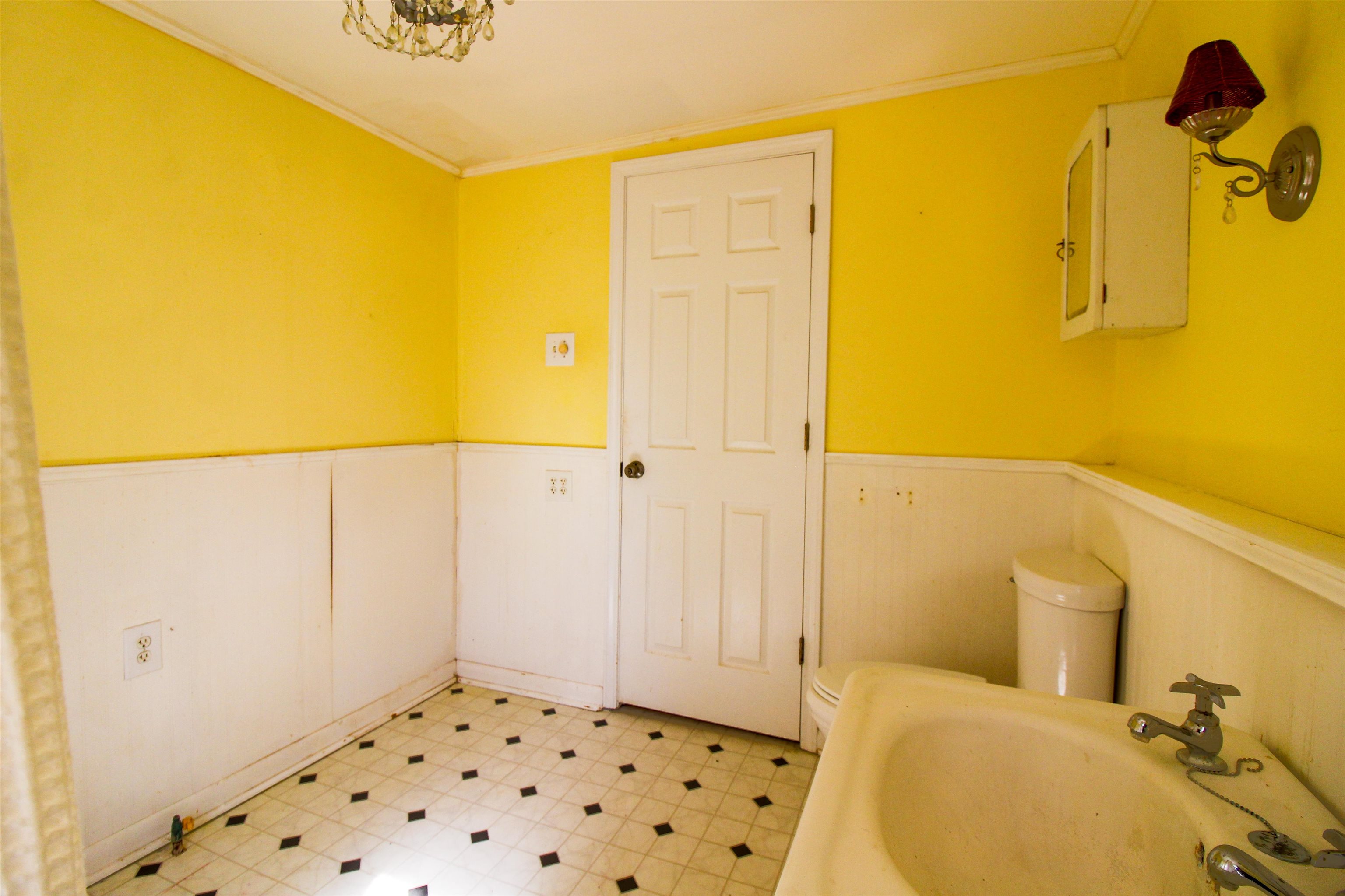 143 Marys Chapel Road Ripley, TN 38063 - Photo 10 of 23 Full bathroom featuring wainscoting ,crown molding and claw foot tub.