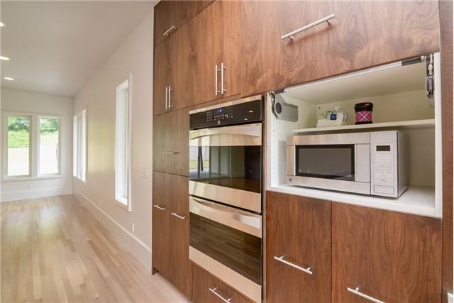 3136 Southall Road Franklin, TN 37064 - Photo 6 of 20 Microwave is hidden to the right of the double ovens and a coffee bar is on the left