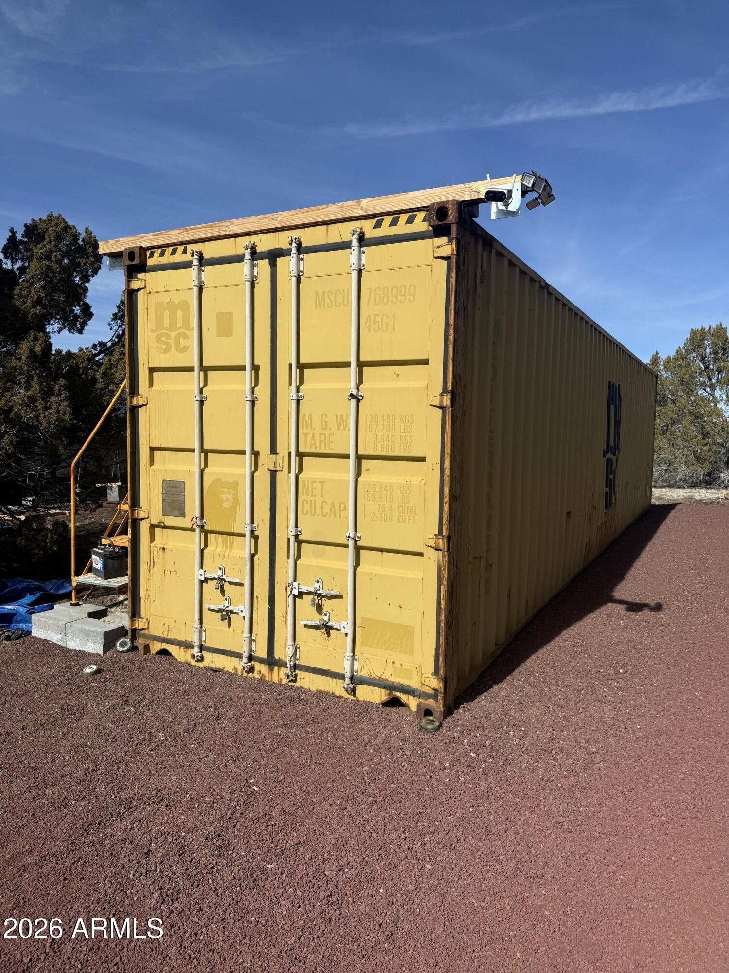 5892 North Santa Fe Road, Unit 99 Williams, AZ 86046 - Photo 12 of 29 a view of a garage with wooden floor and a window