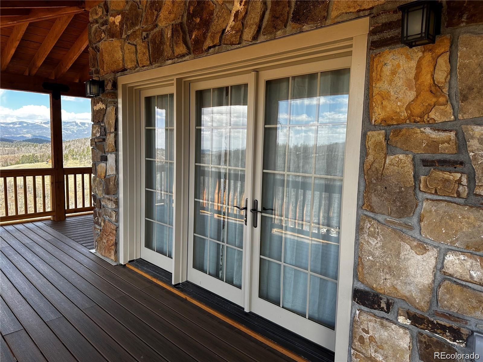 406-449 Schierl Road Fort Garland, CO 81133 - Photo 5 of 50 a view of a balcony with wooden floor and iron stairs