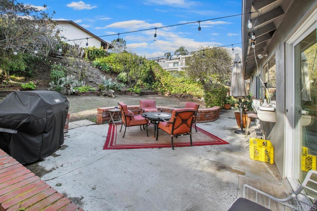 13260 Carousel Lane Del Mar, CA 92014 - Photo 4 of 10 a view of a patio with a table and chairs and potted plants