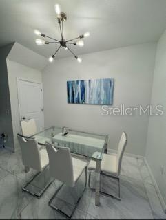 8836 Indigo Trail Loop Riverview, FL 33578 - Photo 6 of 11 a room with a table chairs and wooden floor