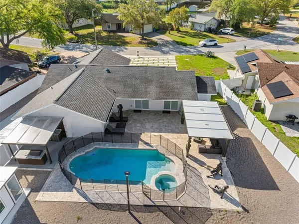 an aerial view of residential houses with outdoor space