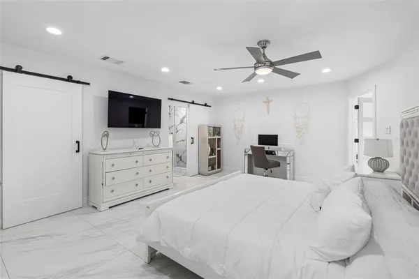 a kitchen with stainless steel appliances kitchen island granite countertop a refrigerator and a stove top oven
