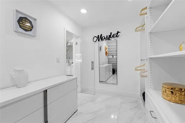a room with stainless steel appliances kitchen island granite countertop furniture a sink and a fireplace