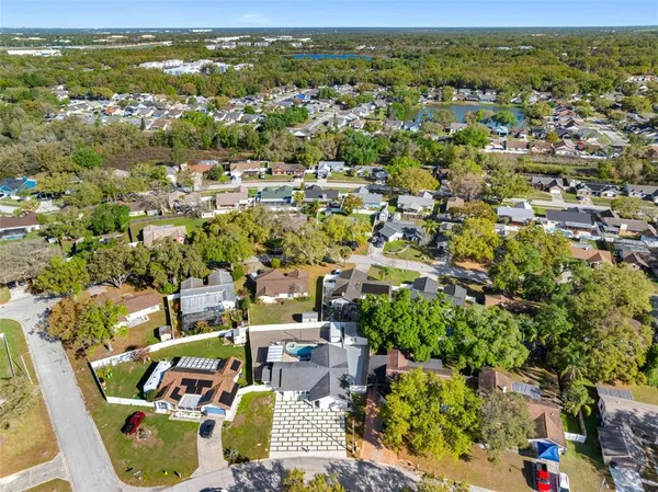 an aerial view of a house with a yard basket ball court and outdoor seating
