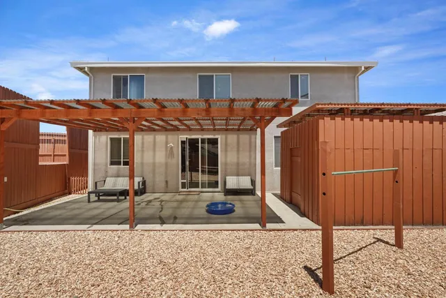 a view of a balcony with wooden floor and fence