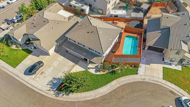 an aerial view of a house with a garden and deck