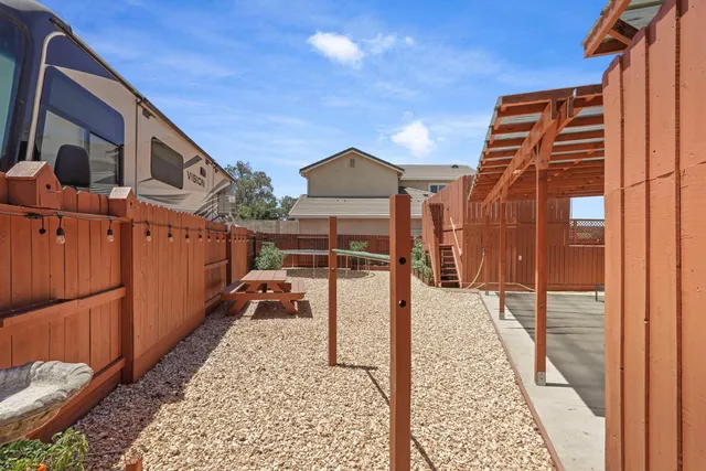 a view of a backyard with wooden fence