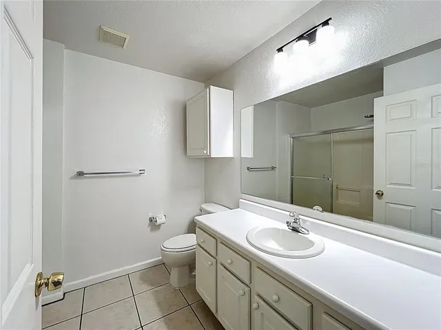 a bathroom with a glass shower door