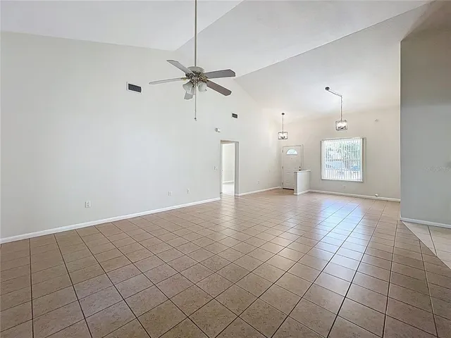 a view of an empty room and a bathroom