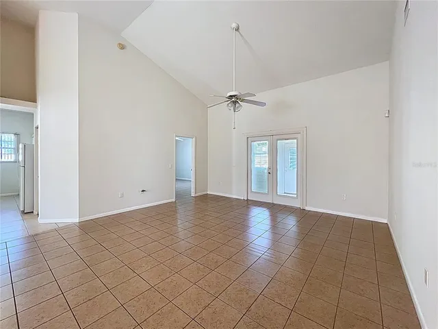 a view of a kitchen with furniture and an empty room