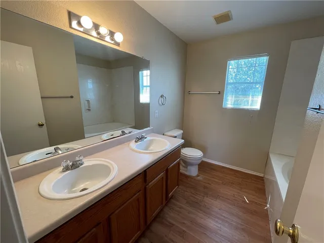 a bathroom with a double vanity sink and a mirror