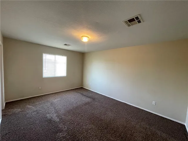 an empty room with a empty space and windows