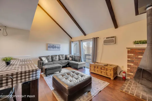 a bedroom with a bed and a flat tv screen on a dresser