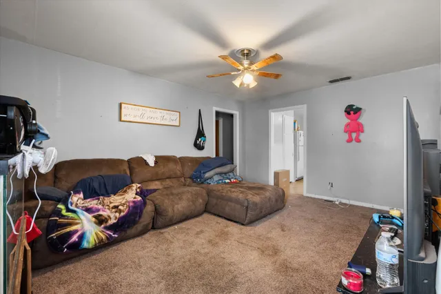 a living room with furniture and a chandelier