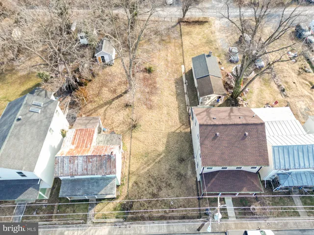 a aerial view of a house with yard and patio